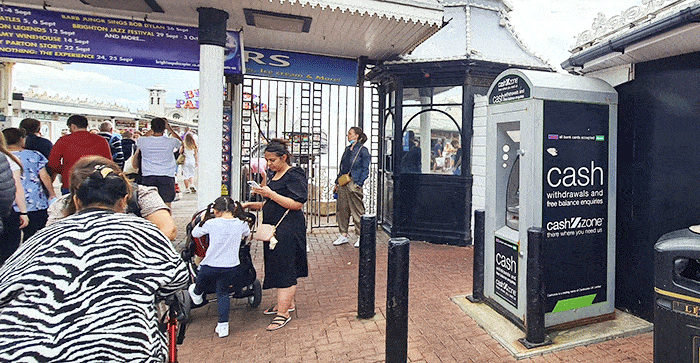 Cash machine by palace pier entrance on Brighton beach